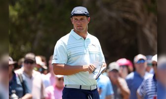 Top players stand against green reading books